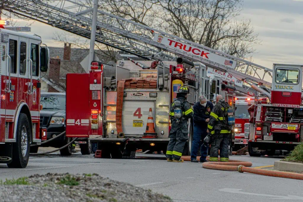 Emergency responders in protective gear gather around red fire trucks and ambulances at an urban emergency scene, with ladder trucks and multiple emergency vehicles visible on a city street lined with bare winter trees." This alt description: Describes the key visual elements (emergency responders, fire trucks, protective gear) Provides context about the emergency response setting Connects to the article's themes about crisis response and community safety Remains concise while being descriptive Avoids speculation about the specific type of emergency Focuses on the professional emergency response, which relates to the article's discussion of coordinated intervention and community action RetryClaude can make mistakes. Please double-check responses.